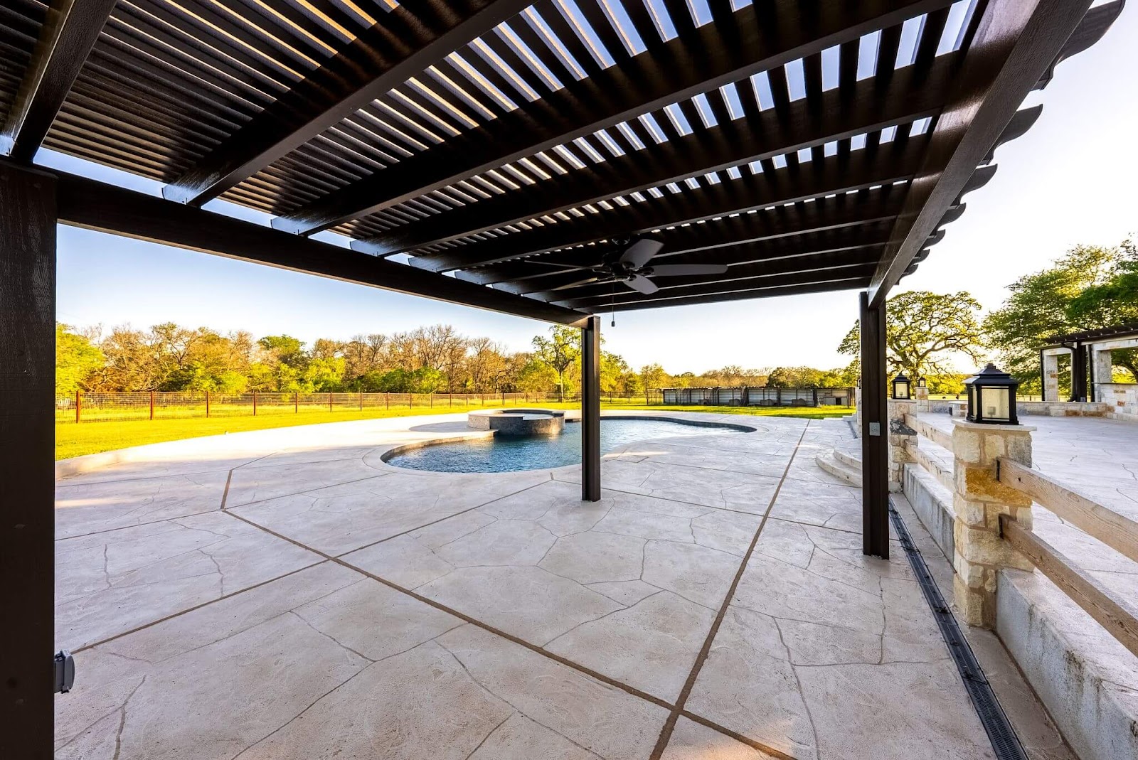 slatted pergola roof on outdoor stone pool deck in dallas-fort worth