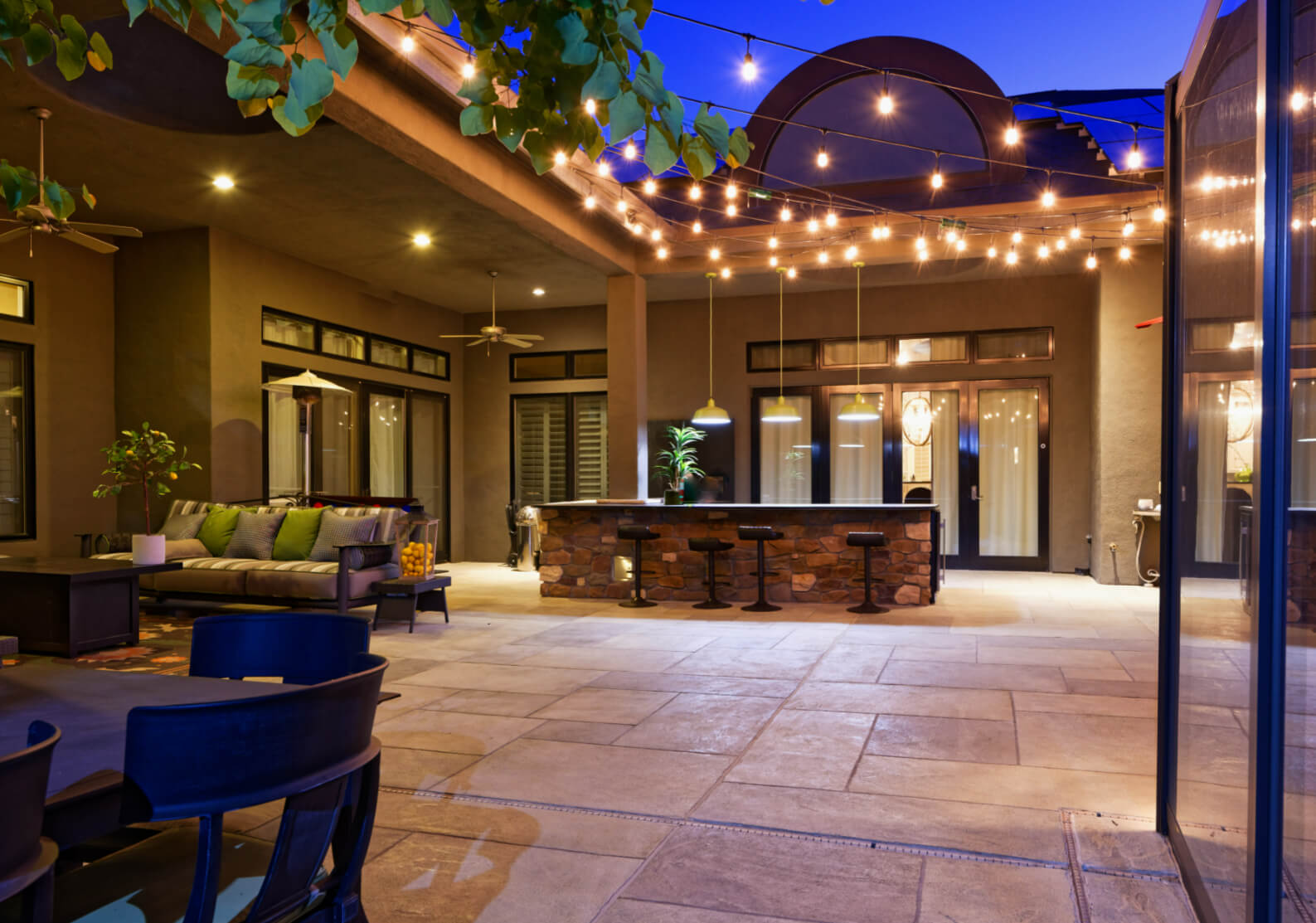 san antonio river walk style home outdoor patio and outdoor bar with string lights