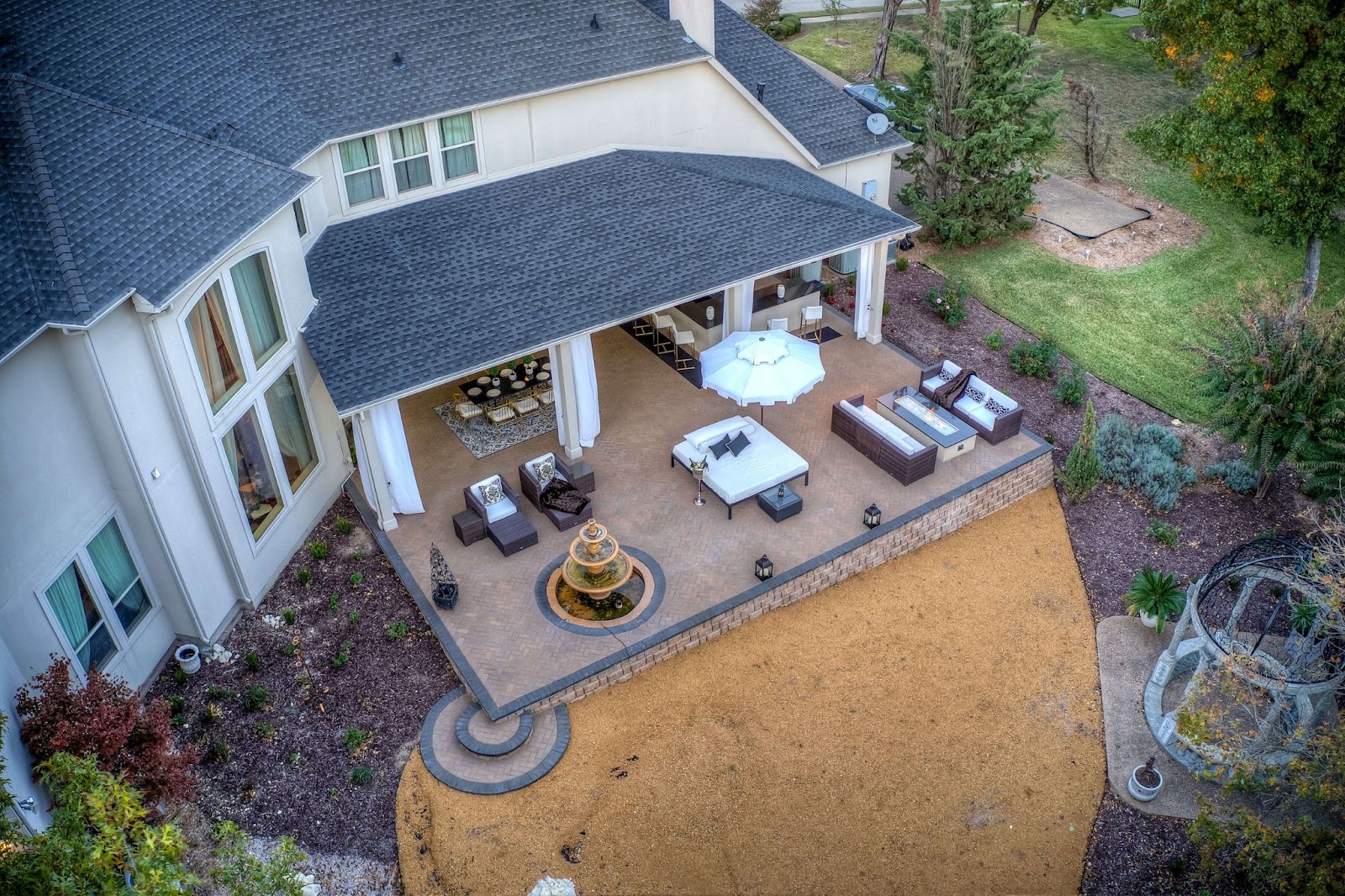 renovated TX outdoor patio and backyard living area with fountain, bar, seating and dining area