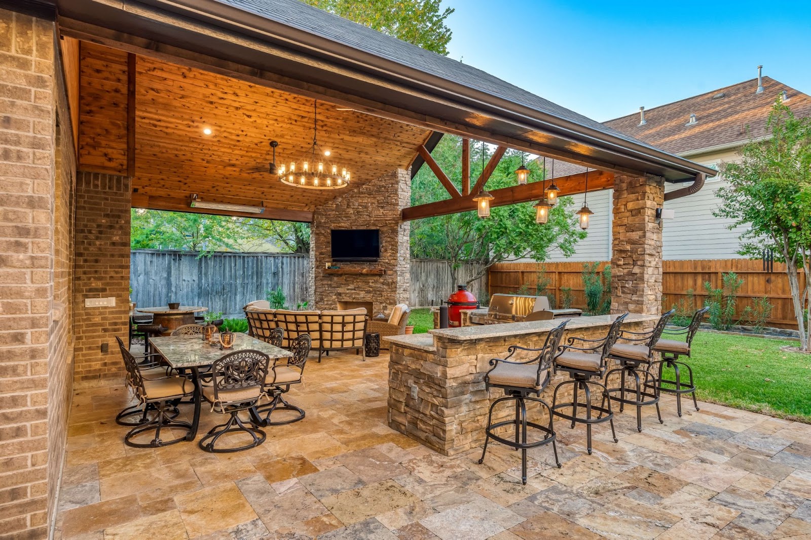 travertine covered patio design with natural brick and entertainment area
