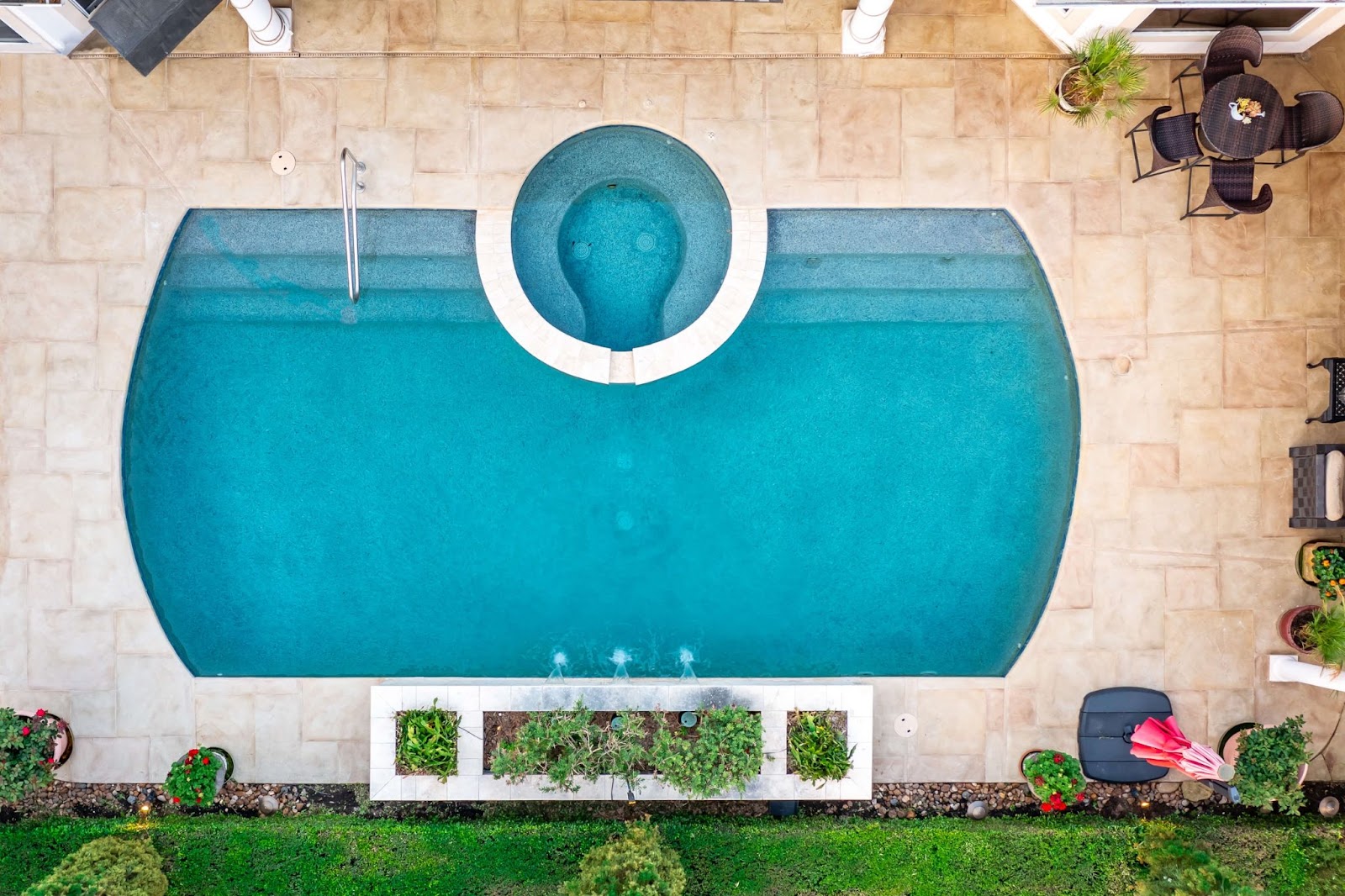 resort style pool refinishing project overhead view with pebble finish and elevated spa