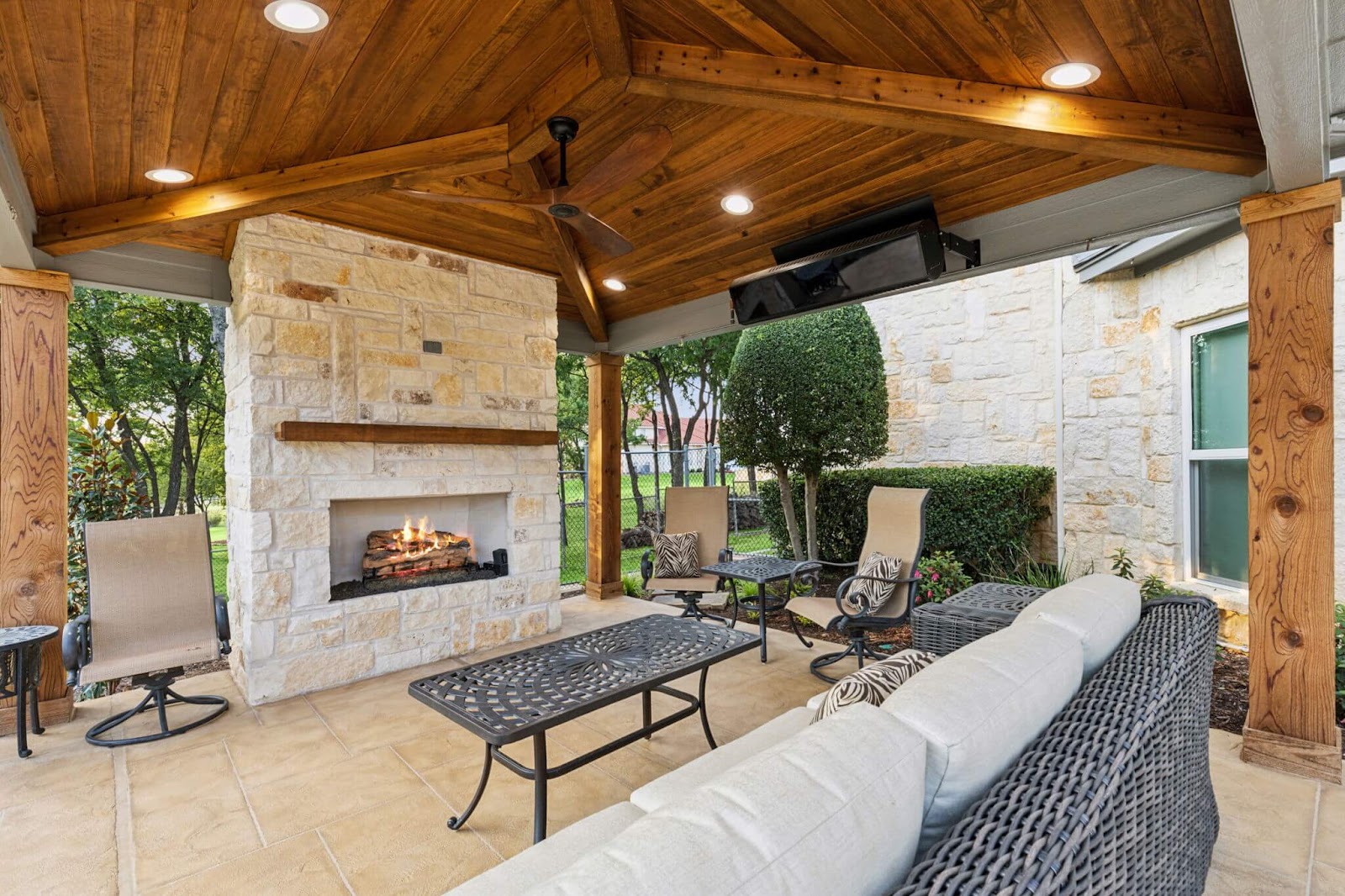 texas outdoor living design with outdoor stone fireplace and seating area