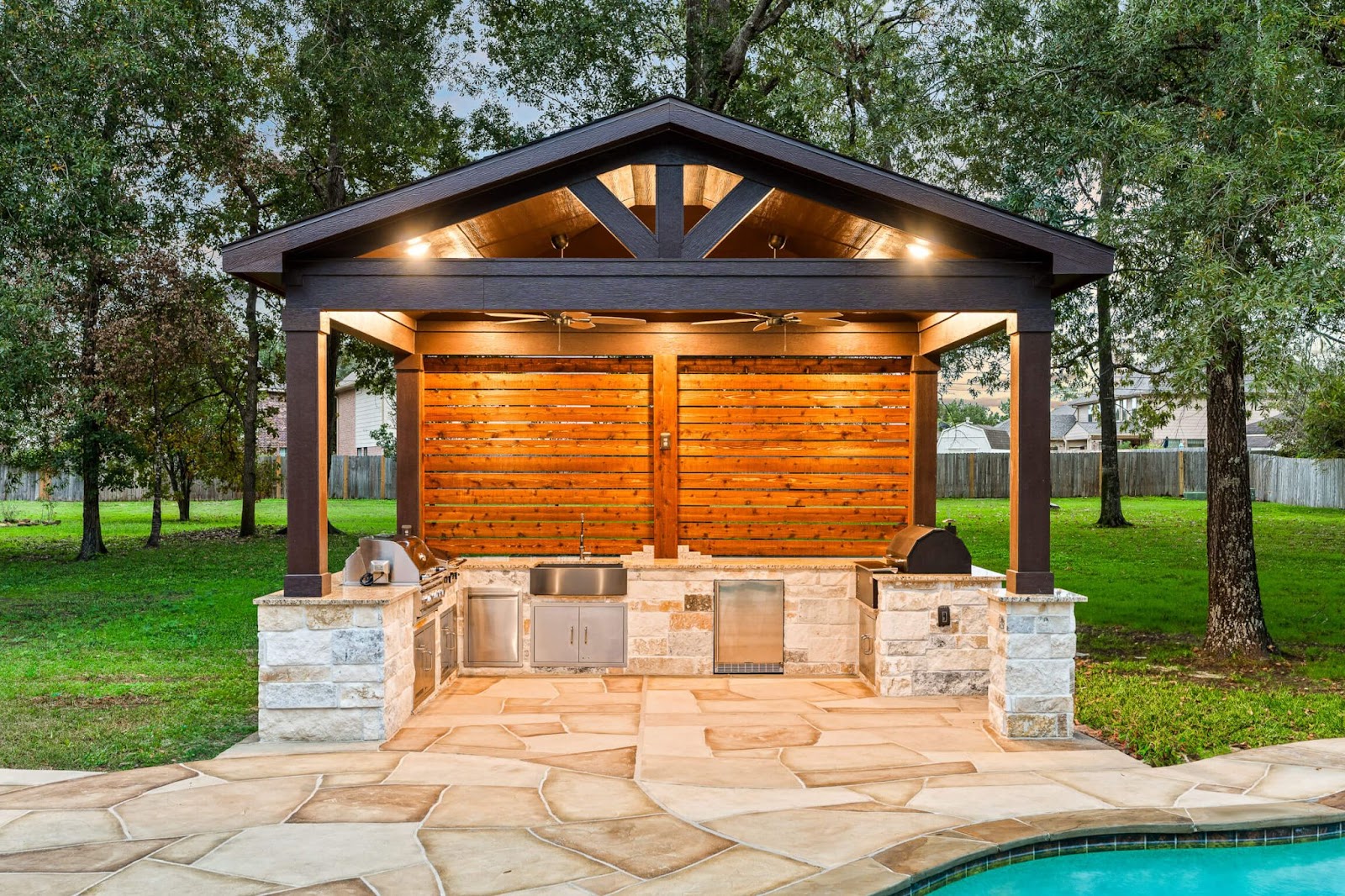concrete overlay pergola and pool deck outdoor living design in texas