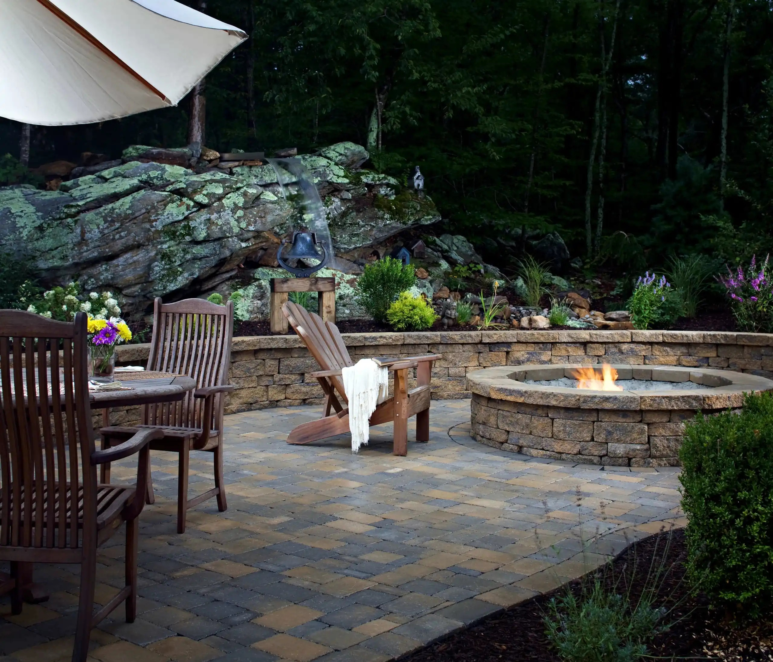 rustic natural stone patio with dining area and custom fire pit, allied outdoor solutions