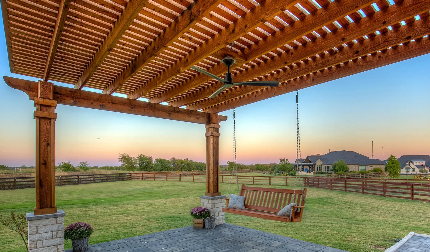 louvered pergola shade structure on outdoor concrete patio in texas backyard