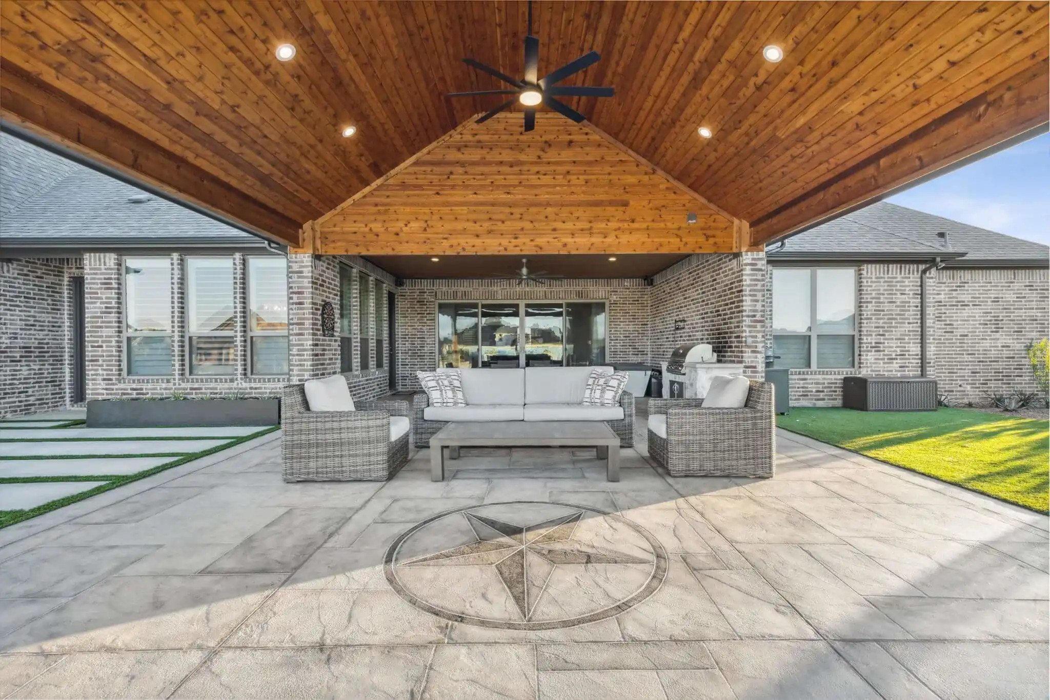 custom carvestone concrete patio design with texas lone star, allied outdoor solutions