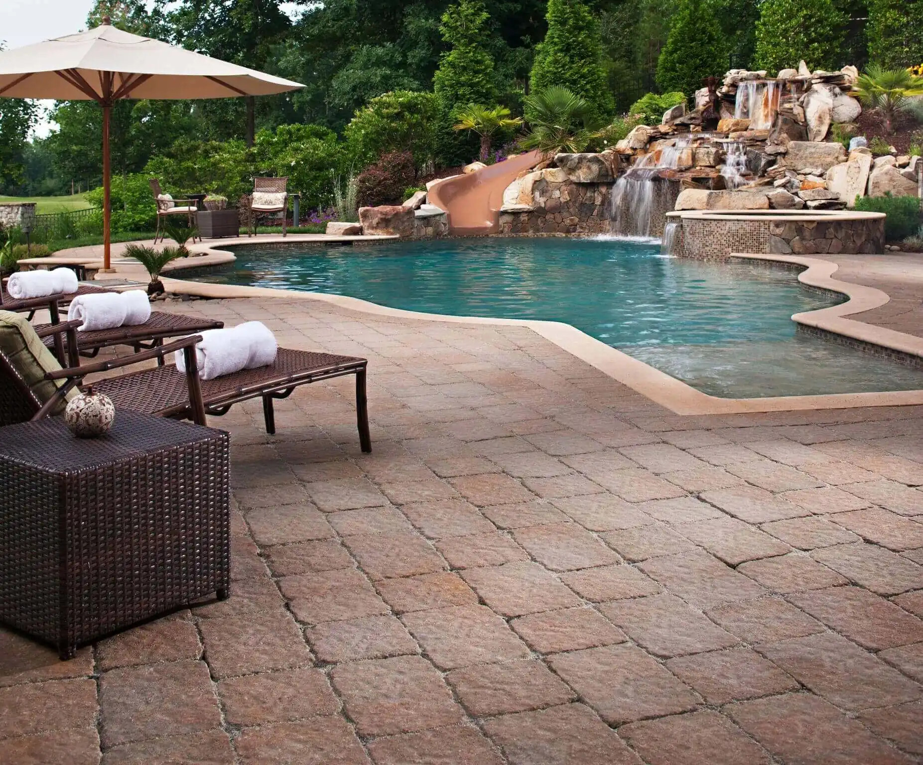 terra cotta spanish style patio and pool with stone waterfall and waterslide