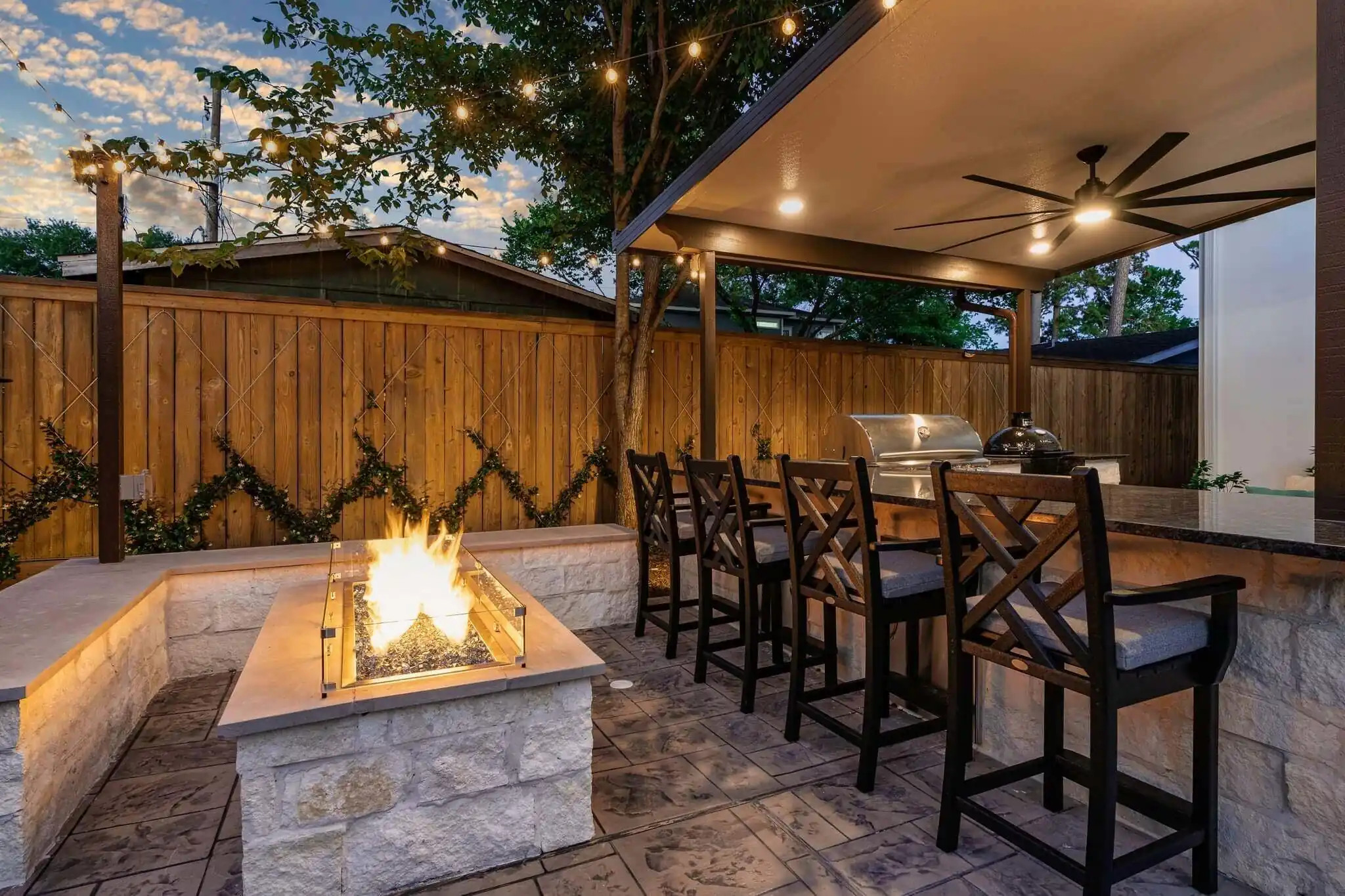 outdoor kitchen and backyard bar design with custom fire feature and premium grill, allied outdoor solutions texas