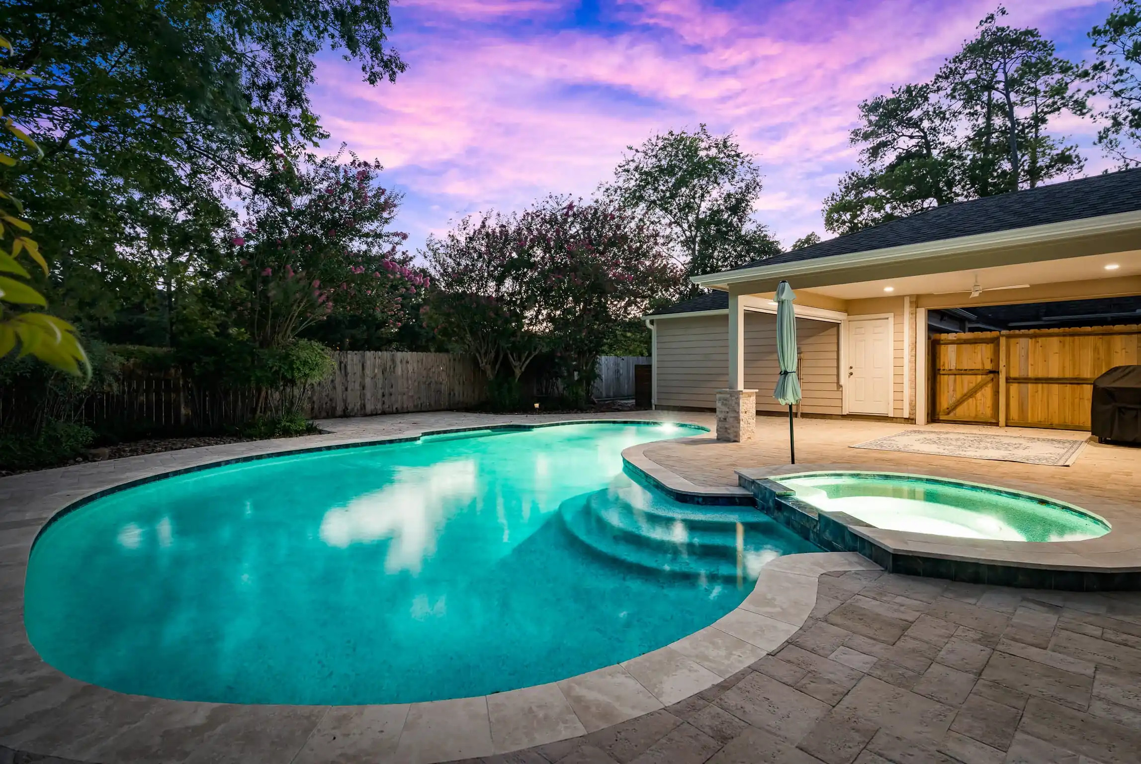 houston backyard pool remodel with attached spa feature and custom pool deck renovation
