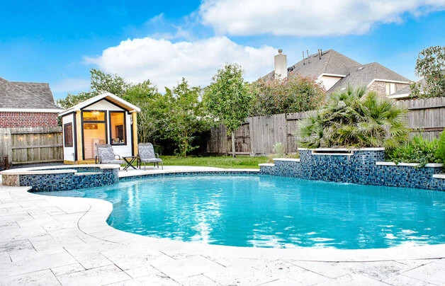 renovated pool in texas with blue quartz plaster and custom waterfall feature