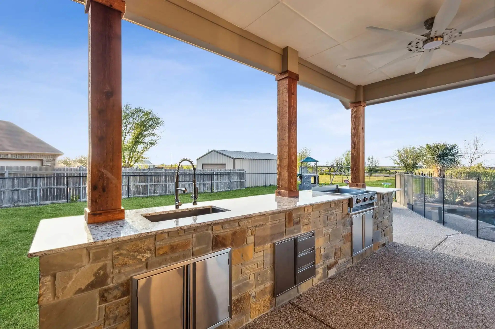 linear kitchen island in texas backyard space