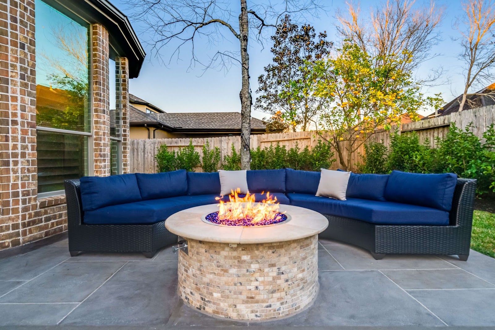 circular natural stone custom fire pit table with sectional outdoor sofa