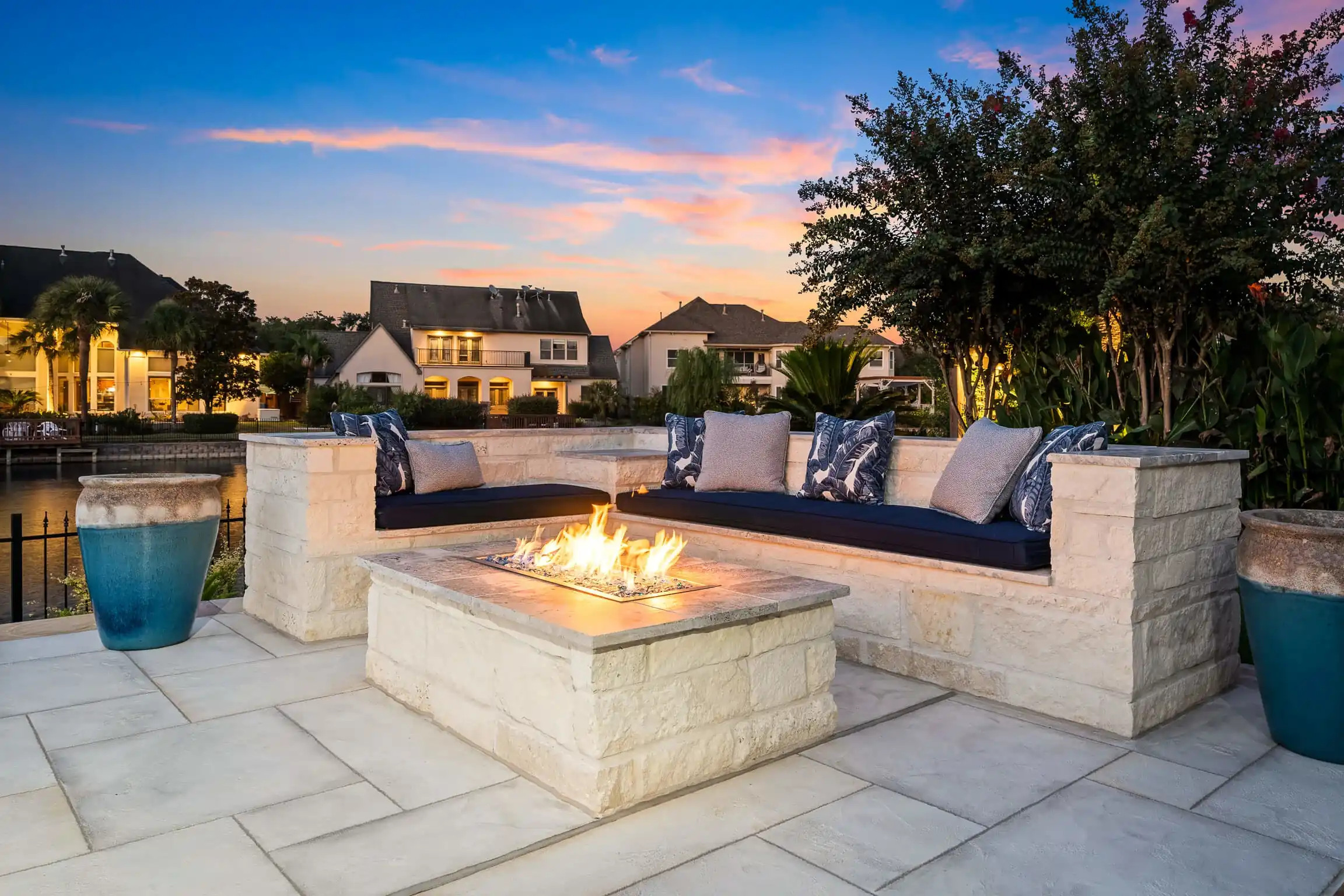 custom fire pit table feature with tempered glass and natural stone surround, texas