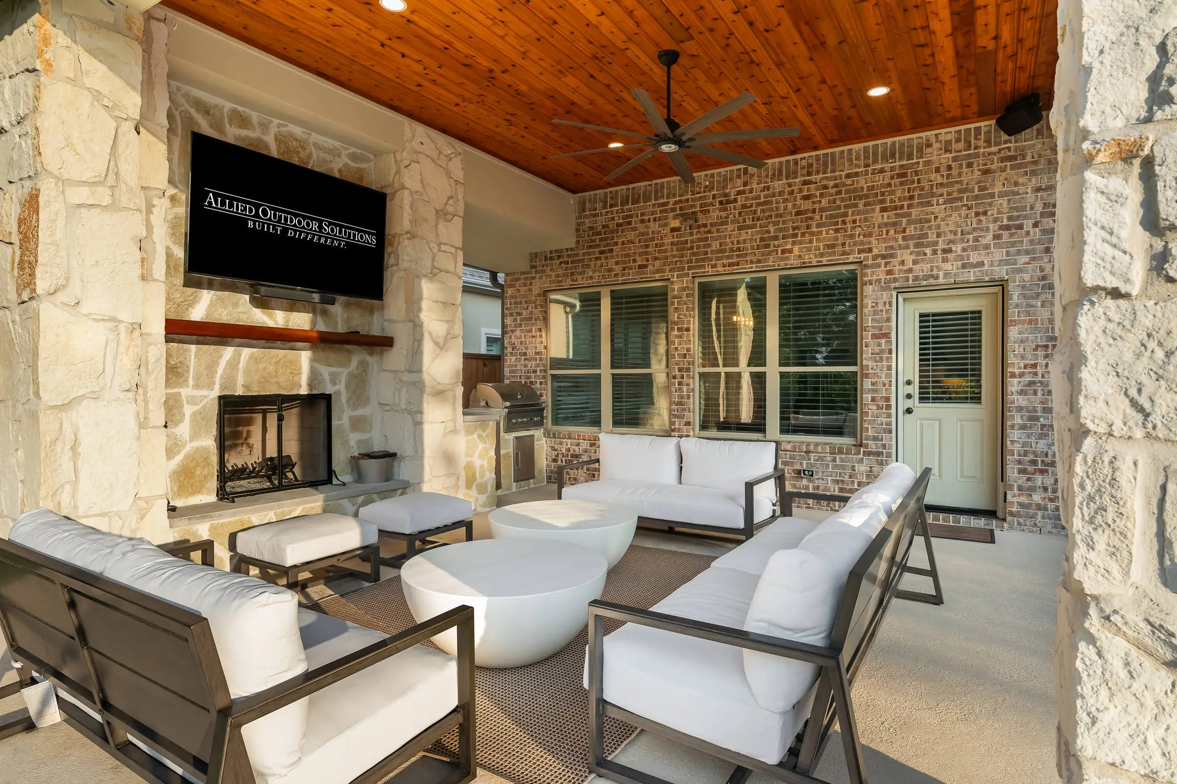 outdoor living room in texas covered patio space, allied outdoor solutions