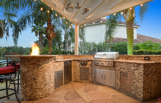 split face travertine custom grill island on outdoor patio