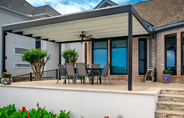 louvered pergola roof on attached patio in texas backyard