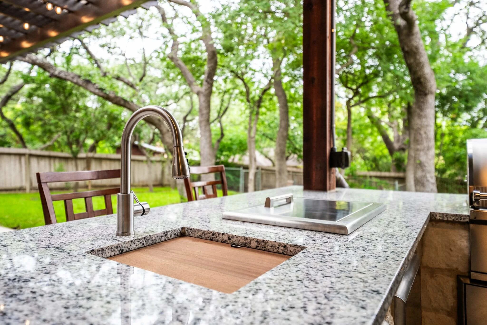 closeup of granite outdoor countertop materials in texas backyard kitchen space