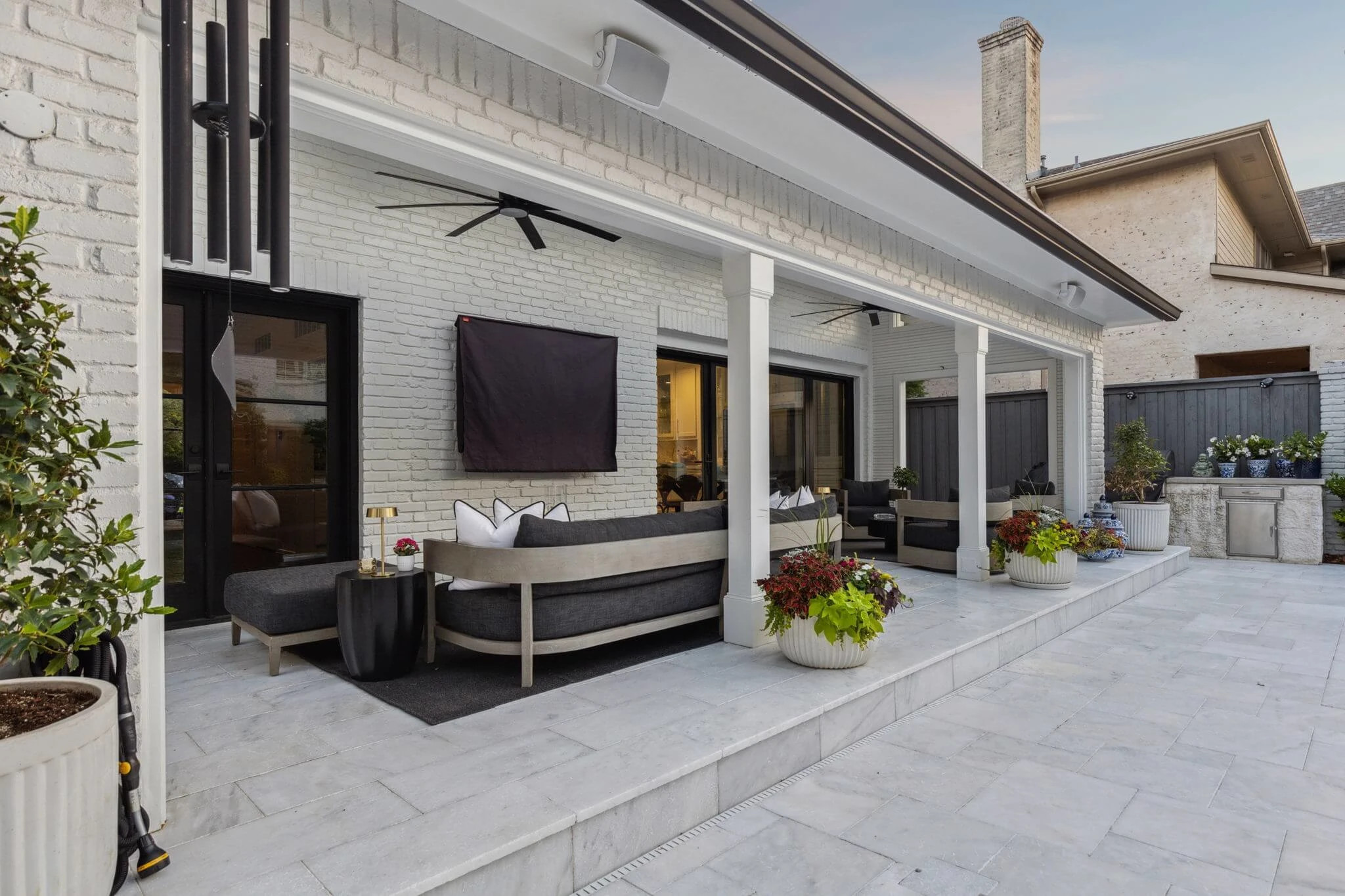 narrow attached patio with furniture, outdoor tv and outdoor grill station, allied outdoor solutions
