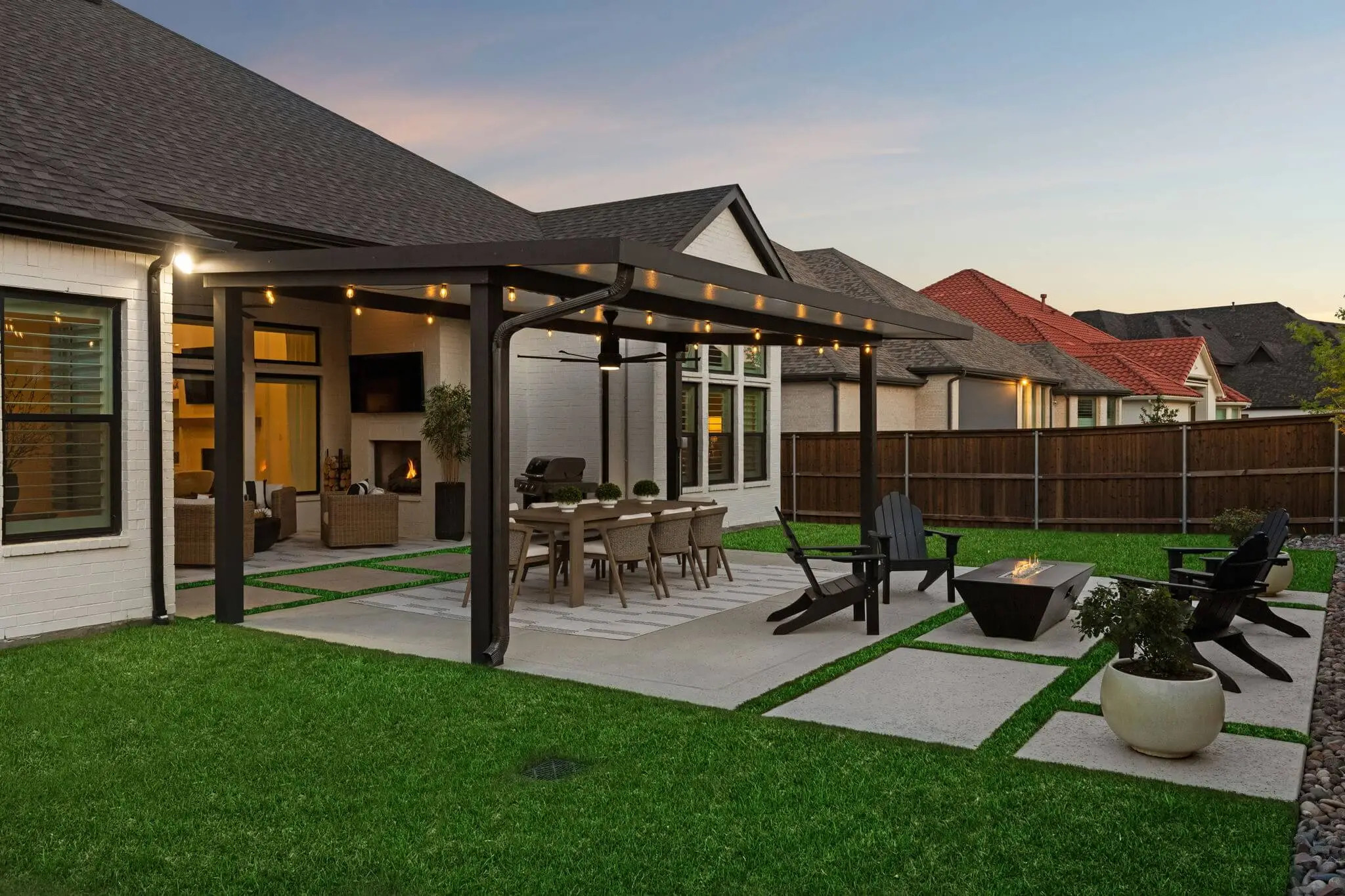 concrete paver patio installation with shade structure and custom fire pit, texas