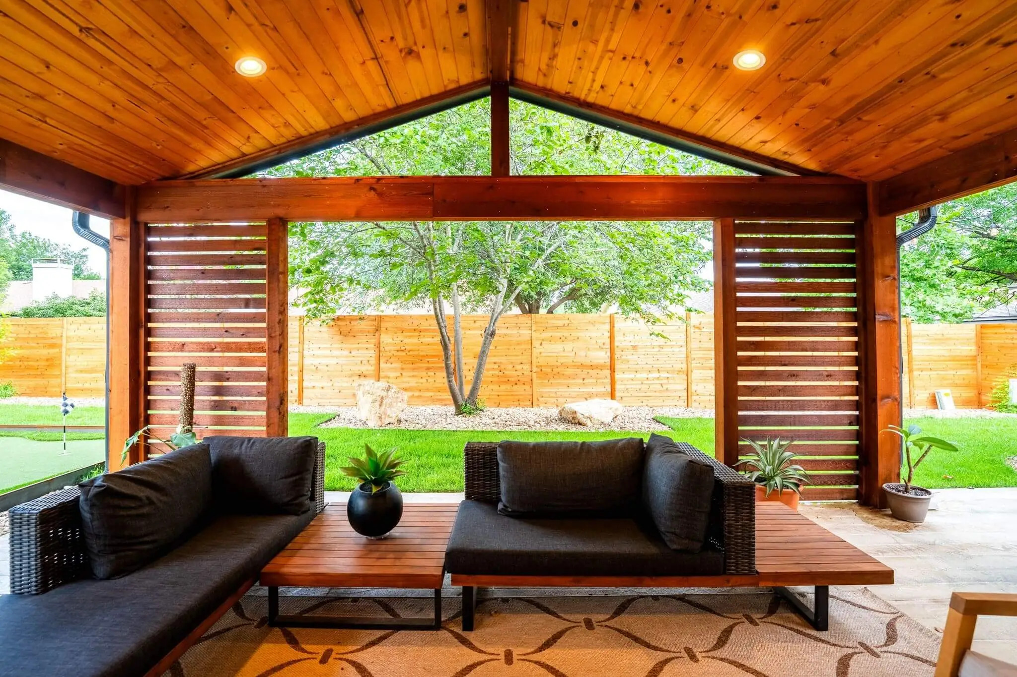 cedar outdoor living room idea with privacy walls and gable roof, allied outdoor solutions in texas