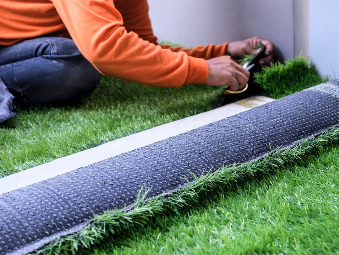 Artificial turf installation with turf edges secured for a seamless lawn